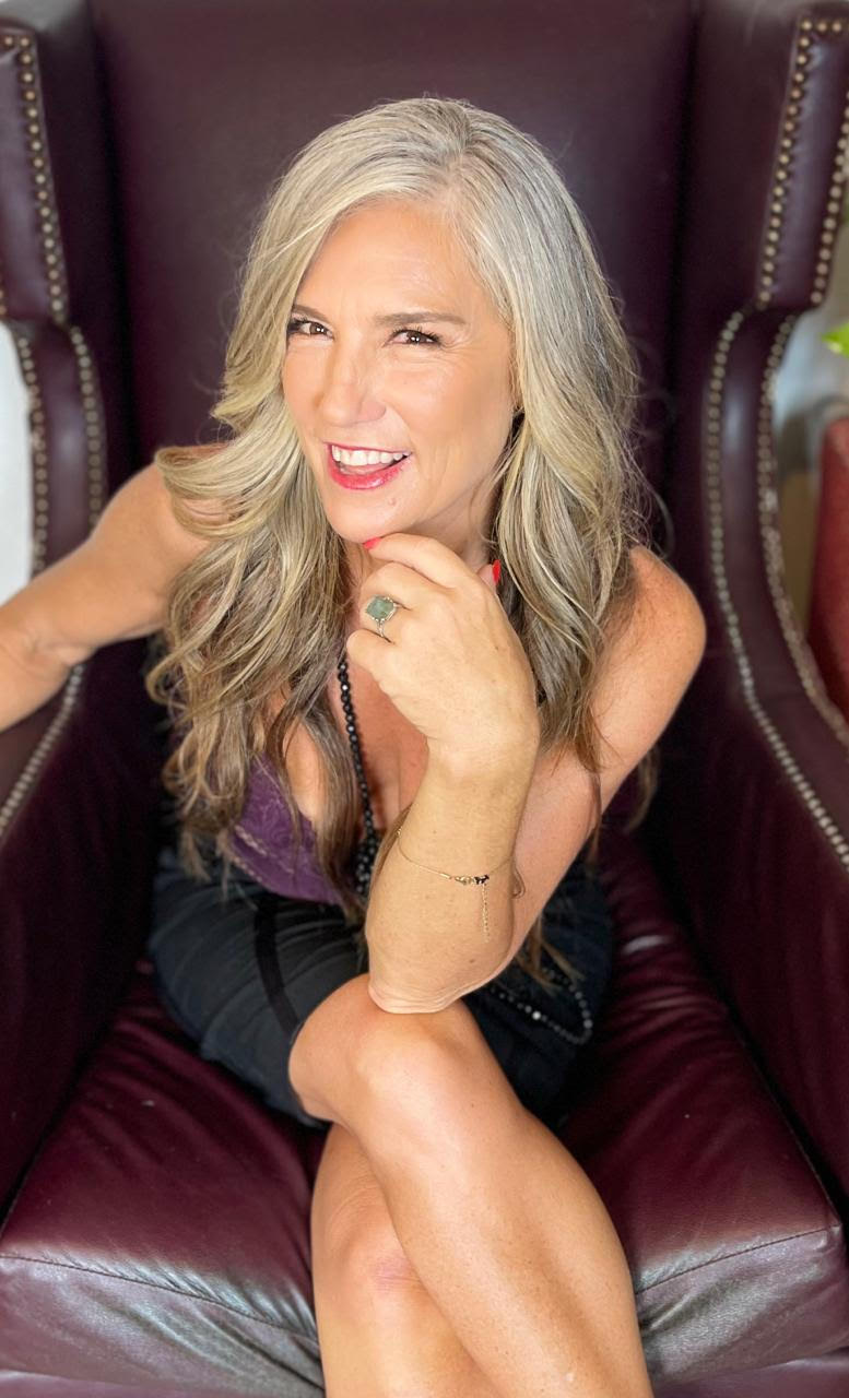 Melissa Louise seated in a wingback chair